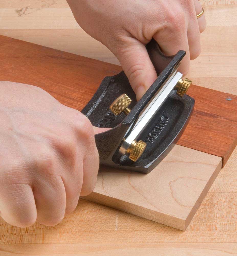 Veritas Cabinet Scraper being used to scrape workpiece.