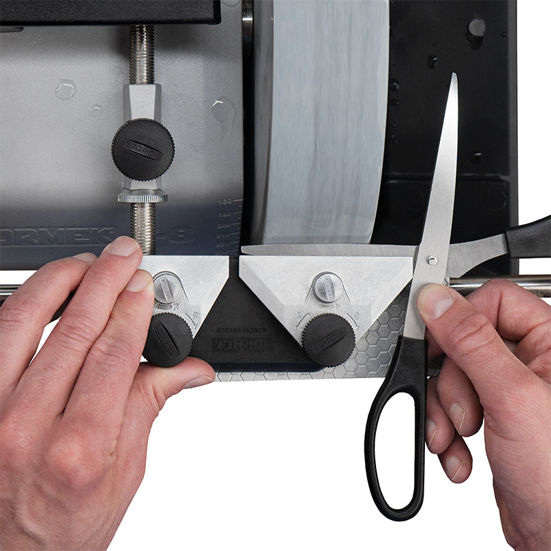 Tormek Scissors Jig being used to sharpen scissors on a Tormek sharpening machine.