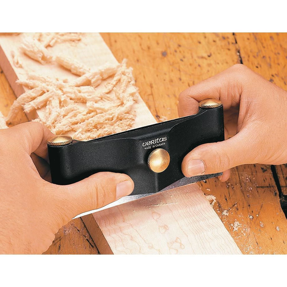 Veritas Cabinet Scraper Holder being used to scrape a piece of timber