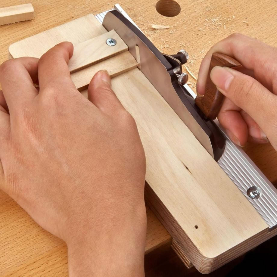 Woodworker using the Veritas Miniature Shooting Board and plane to plane timber