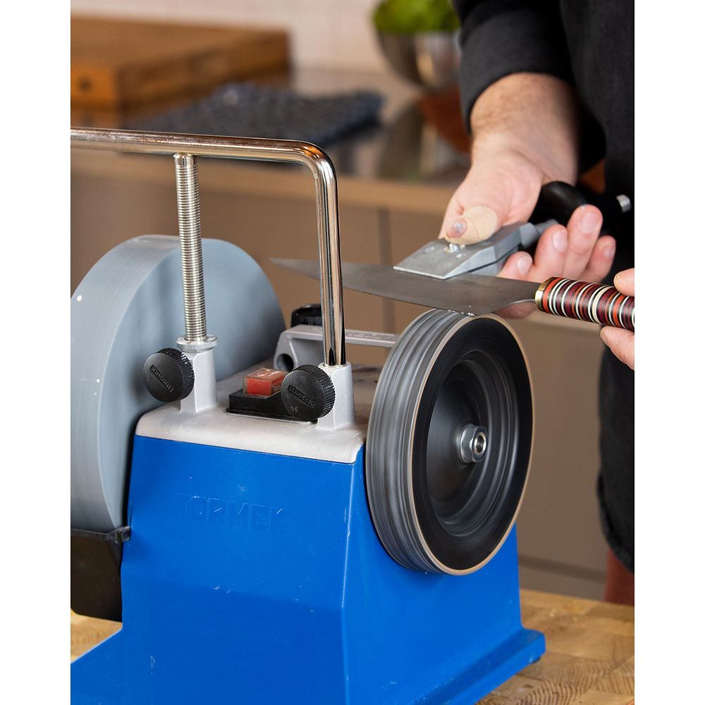 Tormek T-4 Sharpening System being used with knife jig to sharpen a kitchen knife