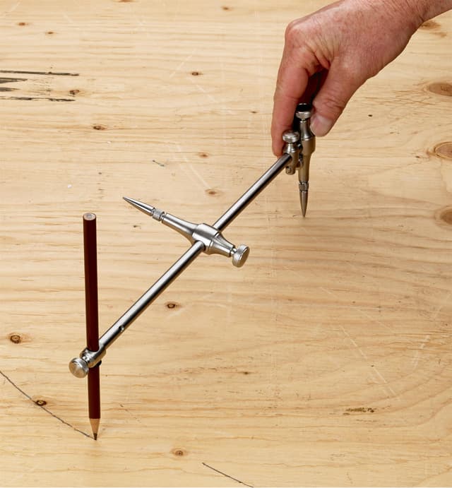 Veritas Beam Compass being used to draw arch into sheet material.