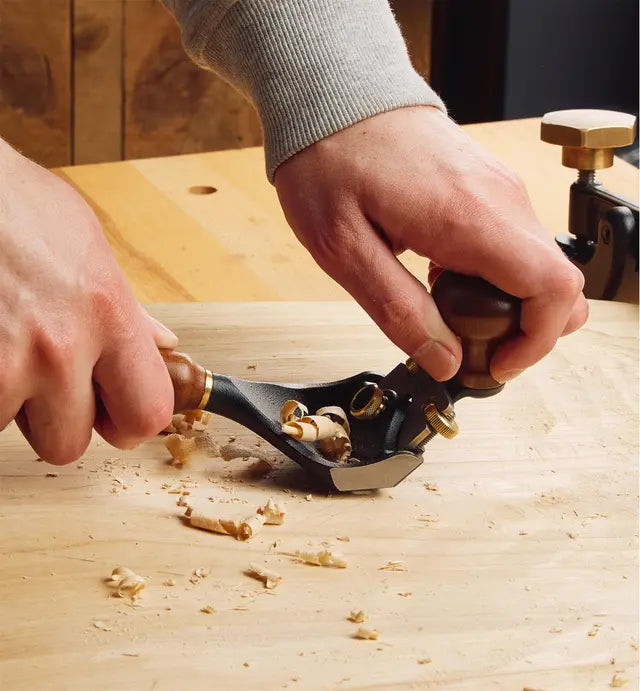 Veritas Pullshave being used to shape a chair seat.
