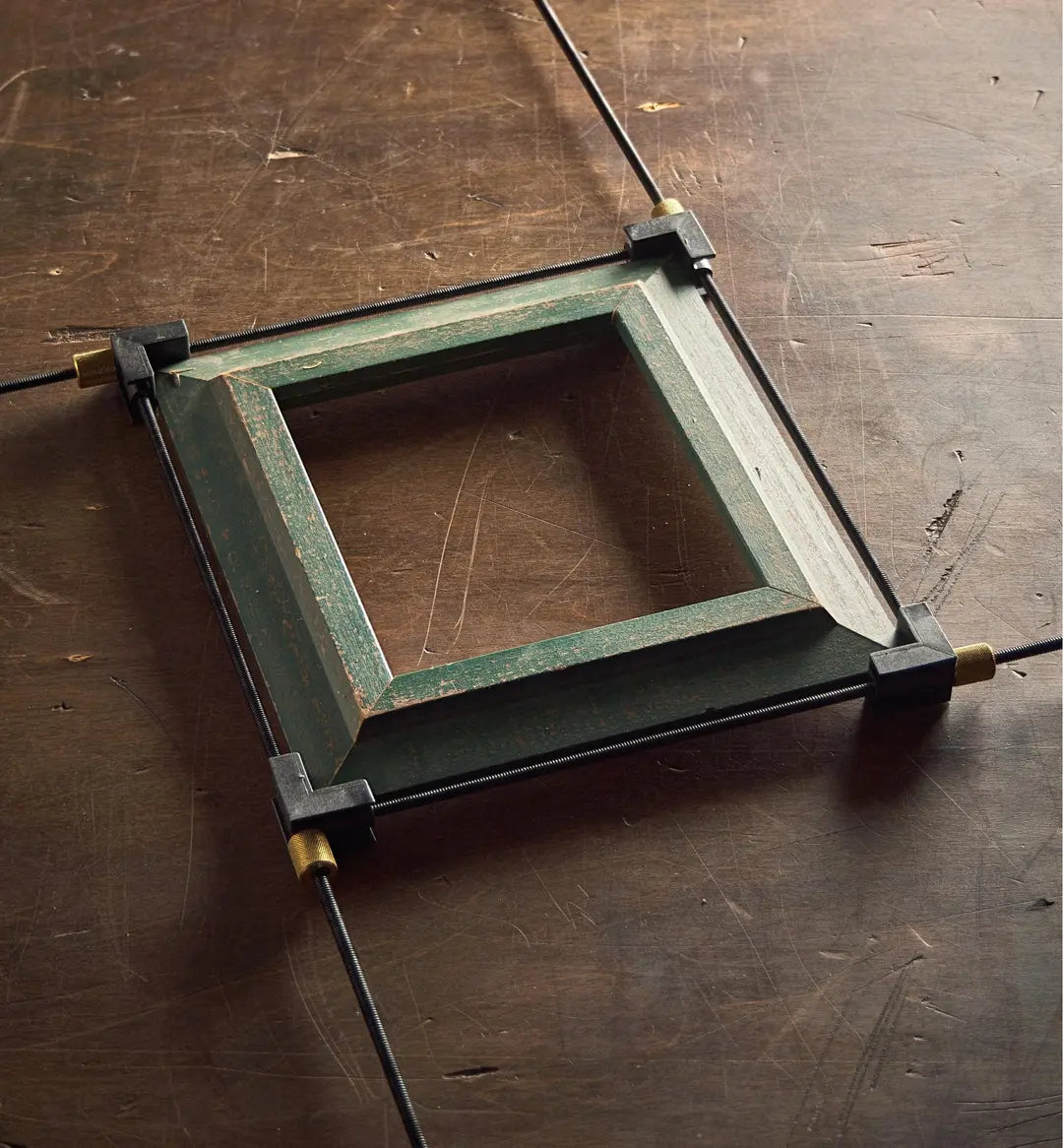 Veritas 4-Way Speed Clamp being used to clamp a vintage picture frame together.