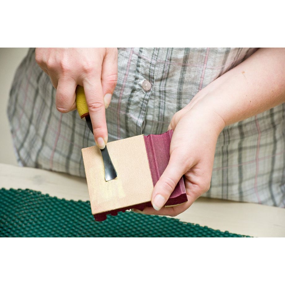 Wood Carver using the Flexcut SlipStrop with Sharpening Compound to sharpen their carving tool