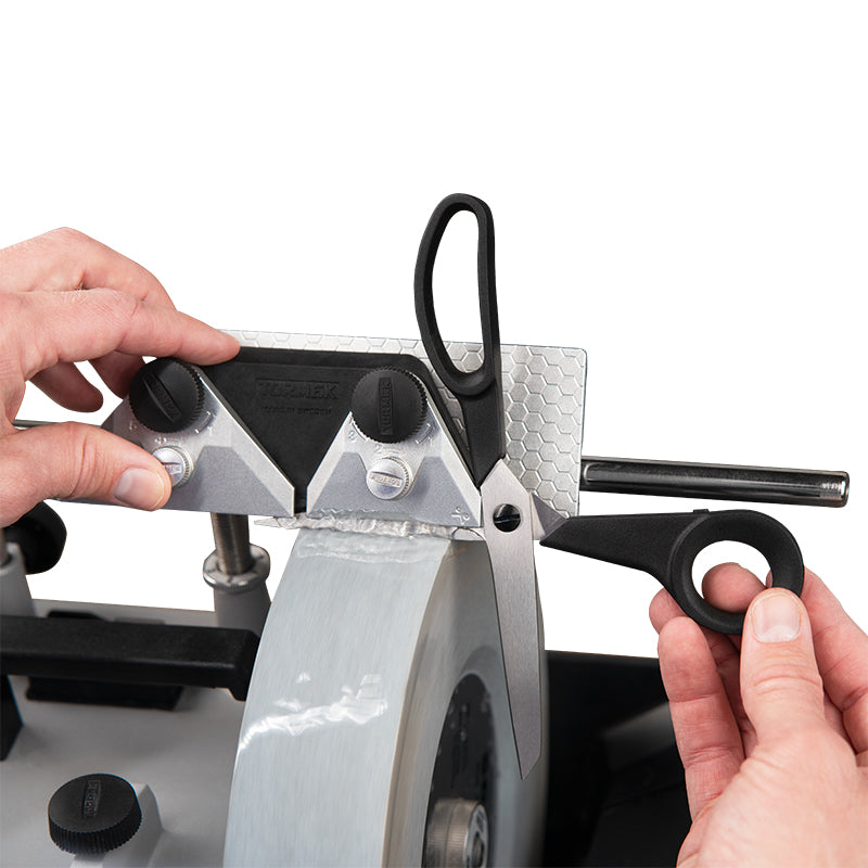 Tormek Scissors Jig being used to sharpen scissors on a Tormek sharpening machine.