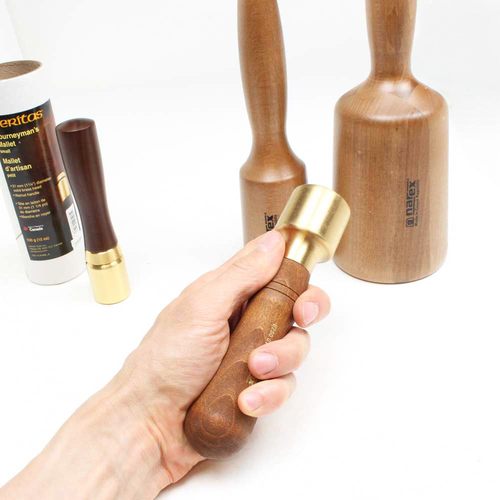 Narex Brass head Carving mallet held in hand with three other sizes shown for comparison