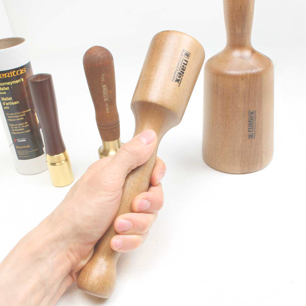 Narex Small wooden Carving mallet held in hand with three other sizes shown for comparison