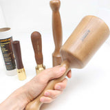 Carving mallet held in hand with three other sizes shown for comparison