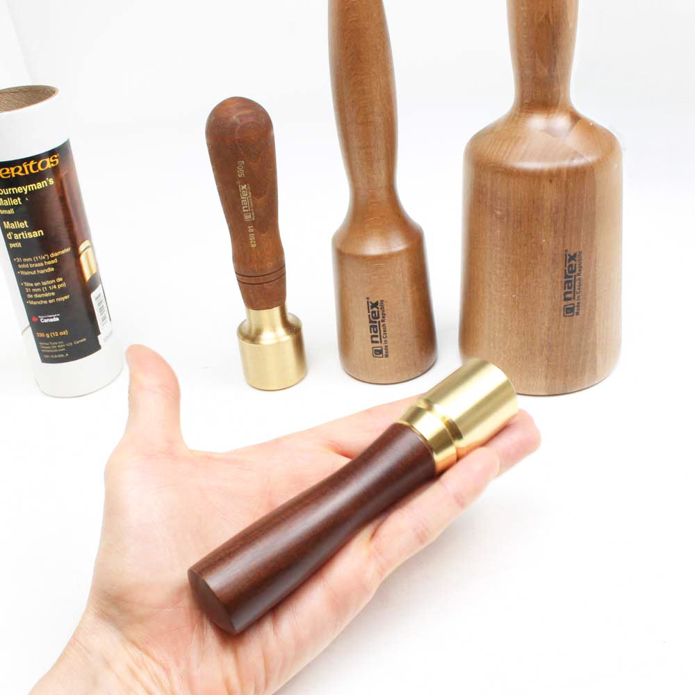 Veritas Carving mallet held in hand with three other sizes shown for comparison