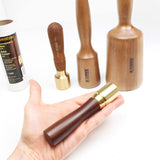 Veritas Carving mallet held in hand with three other sizes shown for comparison