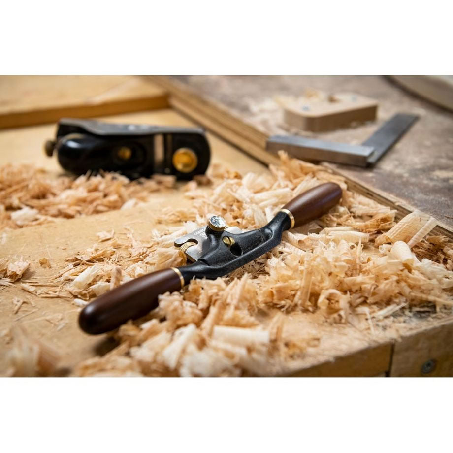 Veritas Round Spokeshave sitting on workbench amongst wood shavings