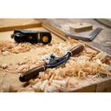 Veritas Round Spokeshave sitting on workbench amongst wood shavings