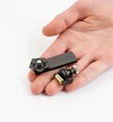 Woodworker holds the Miniature Veritas Honing Guide MK.1 in his palm.