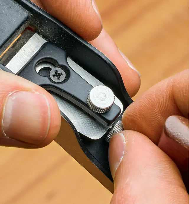 Woodworker adjusting the blade of the Veritas Miniature Bevel-Up Jack Plane 