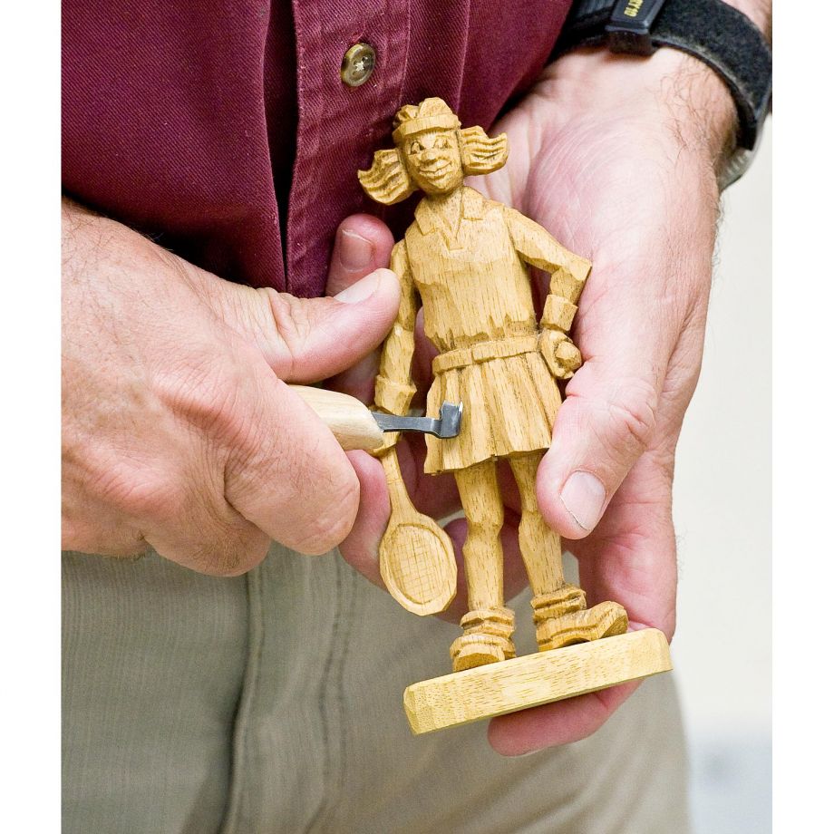 Woodcarver using Flexcut Scorp to carve figure