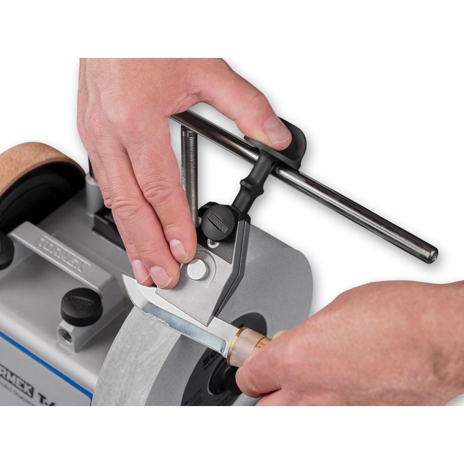 Tormek Centering Knife Jig KJ-45 being used to hold a knife in place over the Tormek Grind Wheel