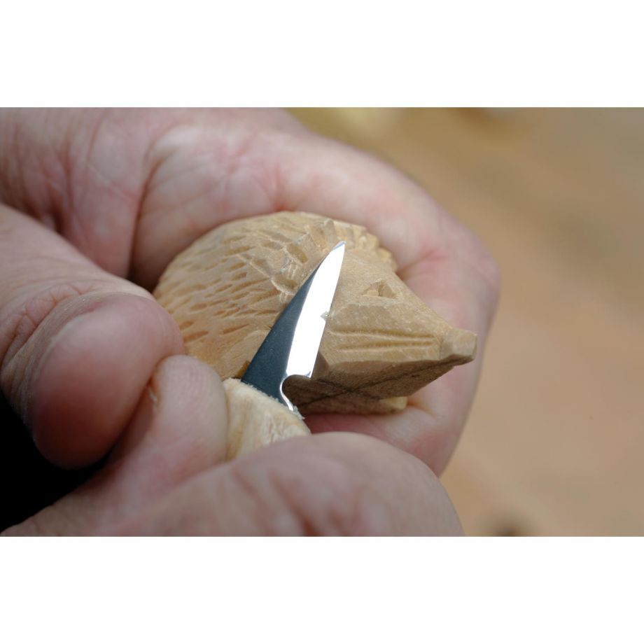 Woodcarver carving a hedgehog with the Flexcut Detail Knife